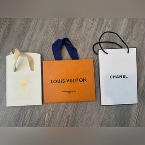 Chanel, Louis Vuitton, and Santa Maria Novella empty shopping bags